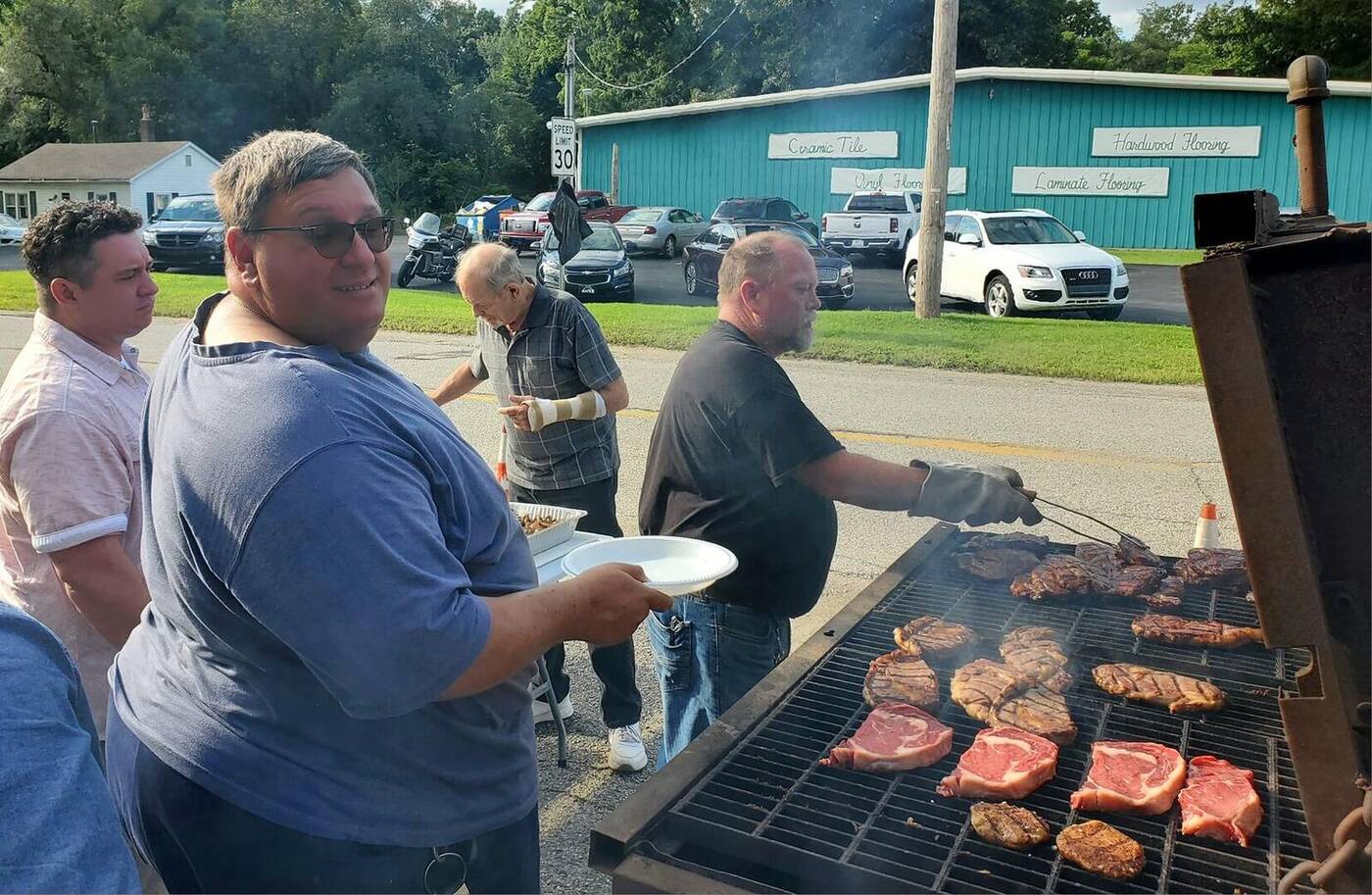 Brothers grilling fresh steaks at the annual steak fry fundraiser